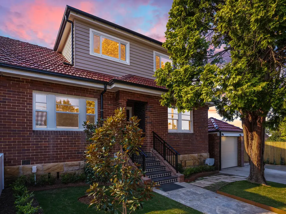 The new weatherboard top storey above the original brick cottage, from the street