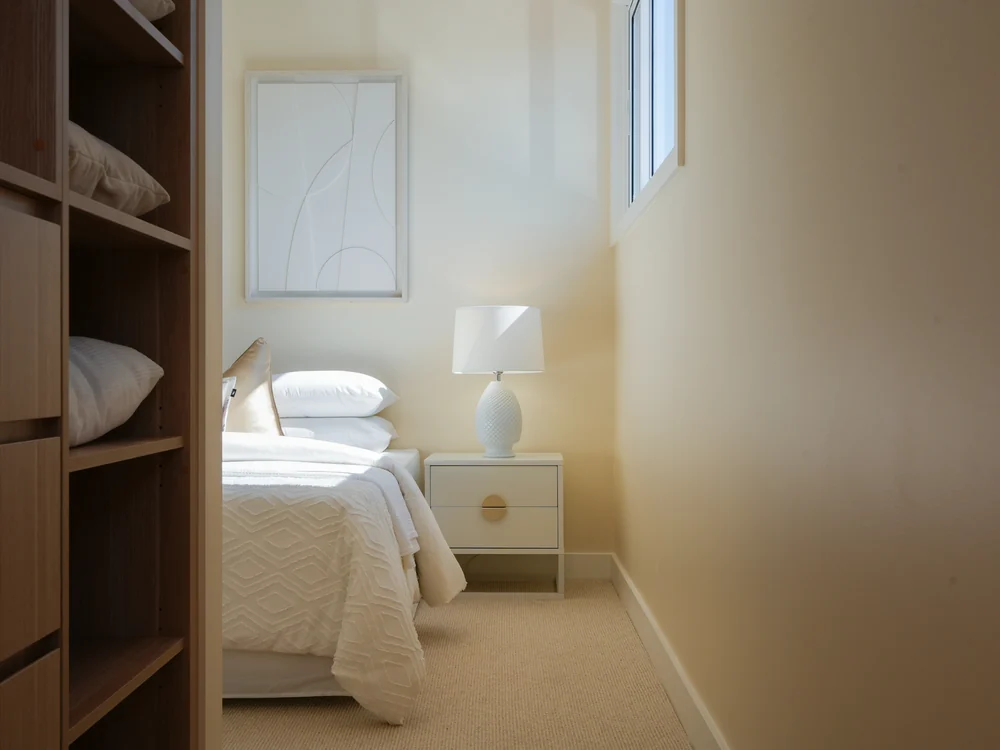Bedroom seen past the built-in wardrobe