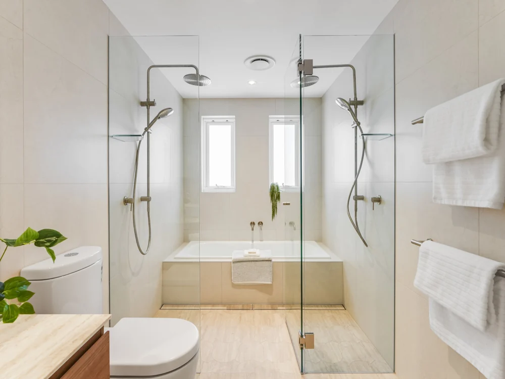 Downstairs bathroom with twin rain showers either side of a tiled bath, 27 Forsyth Street