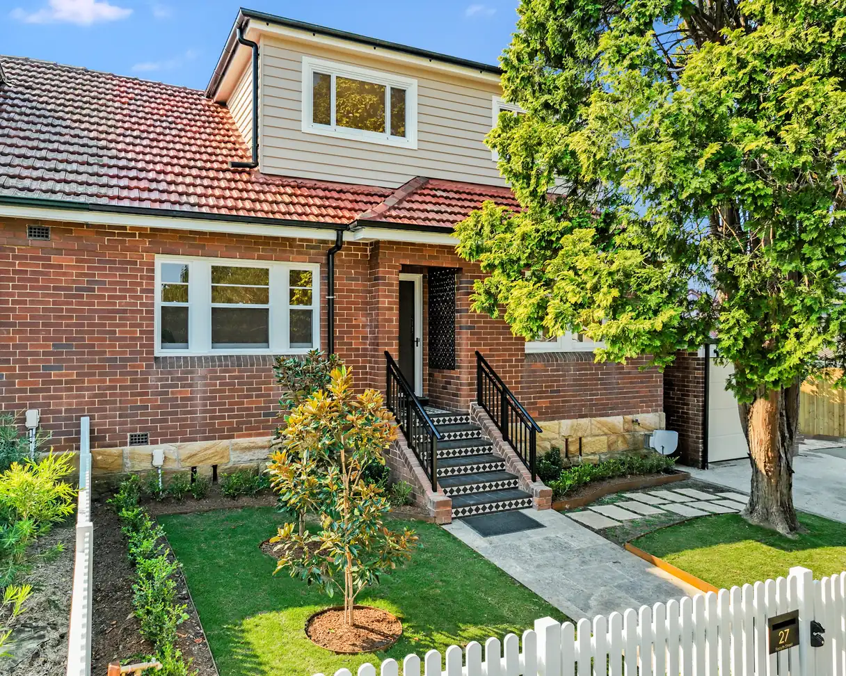 The front of 27 Forsyth Street after the addition, with new lawn, planting and a picket fence