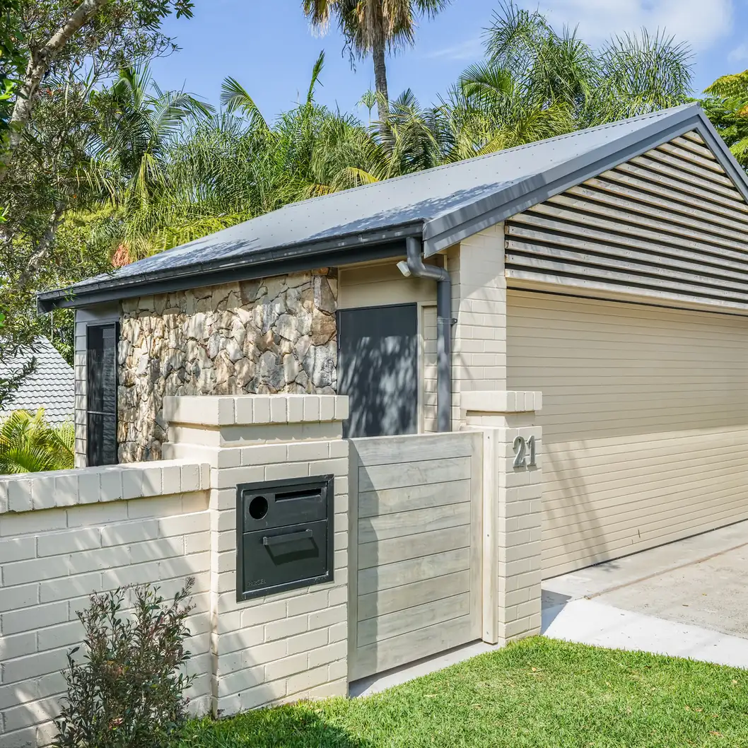 The Mosman studio from the street, reading as a modest garage behind a rendered wall