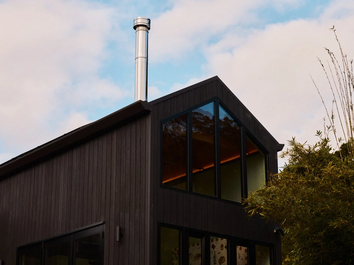The raked gable window and stainless steel flue