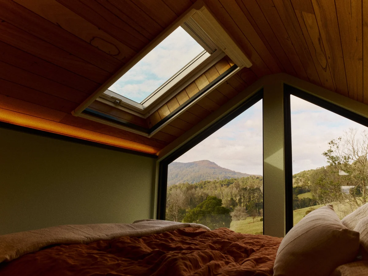Loft bedroom with a skylight and a view down the valley
